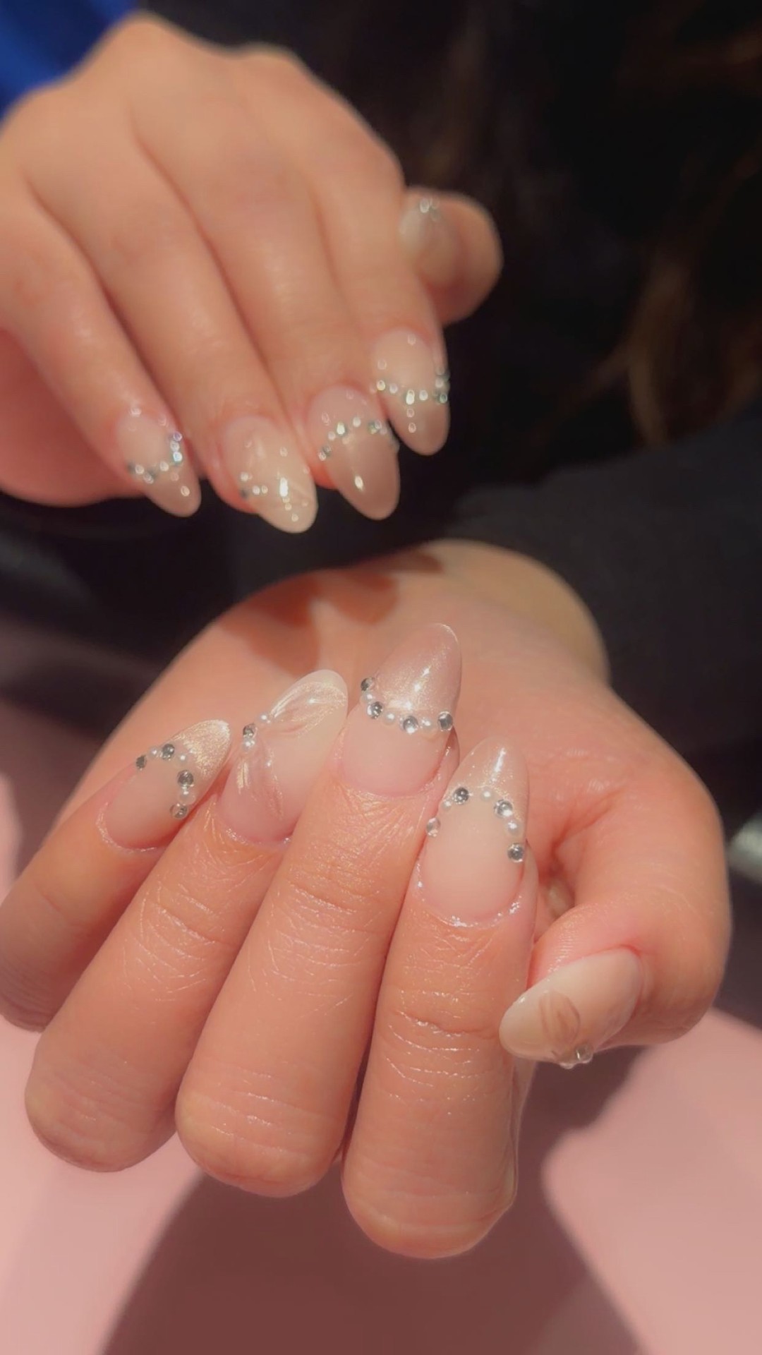 Nude almond nails with delicate crystal detailing